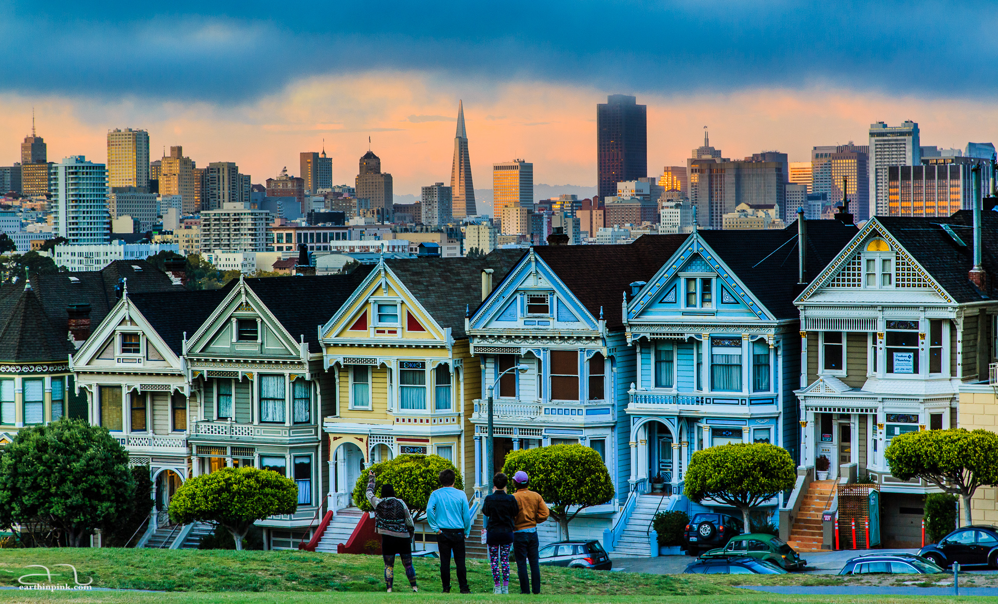 The Victorian architecture of the famous Painted Ladies in Alamo Square contrasts with San Francisco's modern skyscrapers seen in the background.