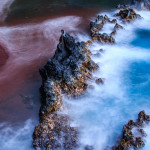 A long exposure of the Red Beach close to Hana shows the contrasting colours of the volcanic sand and the blue ocean waters at dusk.