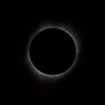 A very short exposure photo that shows the inner corona. I was impressed by the fact that the camera could capture the color of the solar prominences at the top right, which appear red because of Halpha line emission. Photography and physics combined!